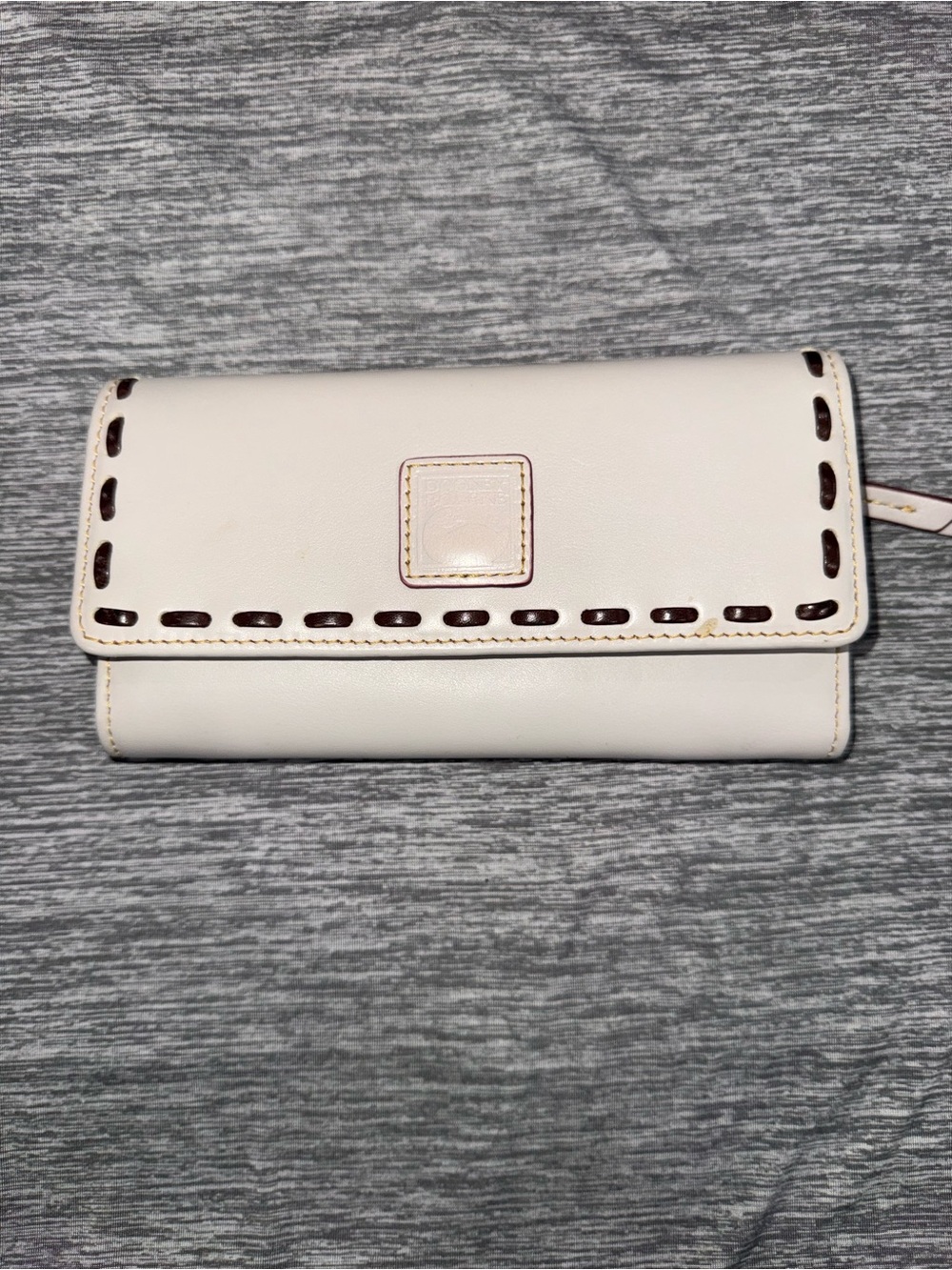 Dooney & Bourke Florentine leather continental wallet in Ecru whipstitch
